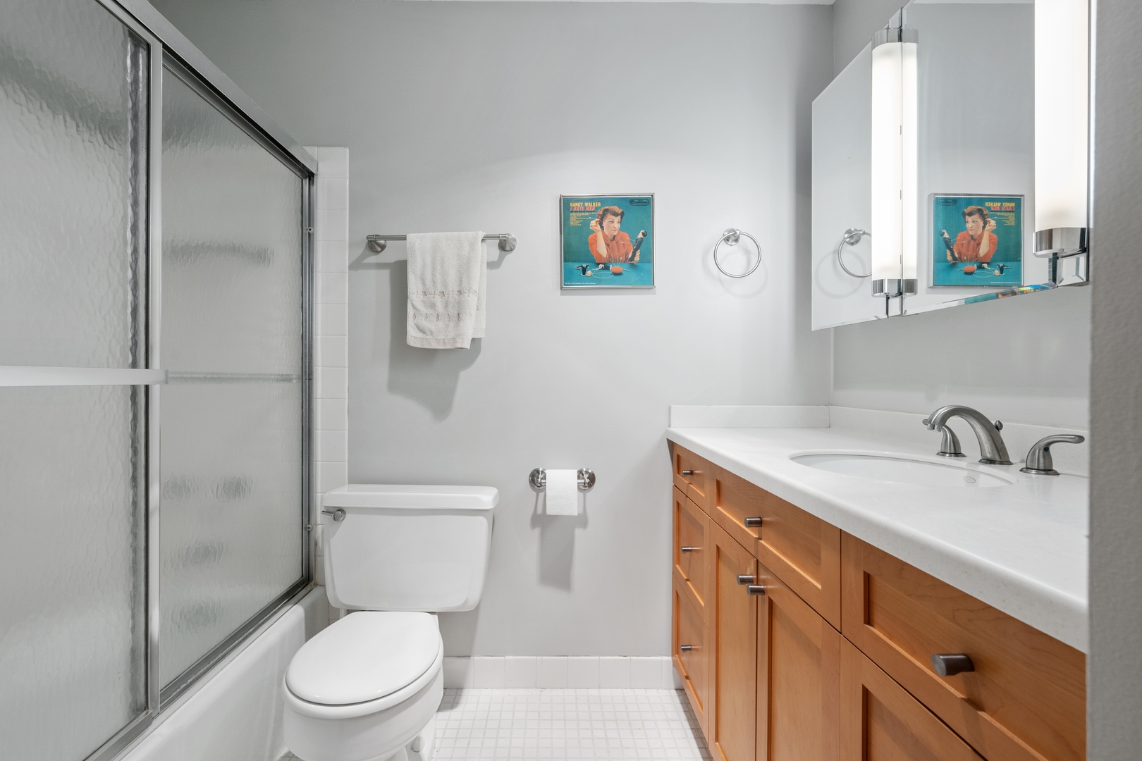 5445 North Sheridan Road, Unit 1212 Chicago, IL 60640 - Photo 11 of 14 a bathroom with a granite countertop toilet sink and mirror