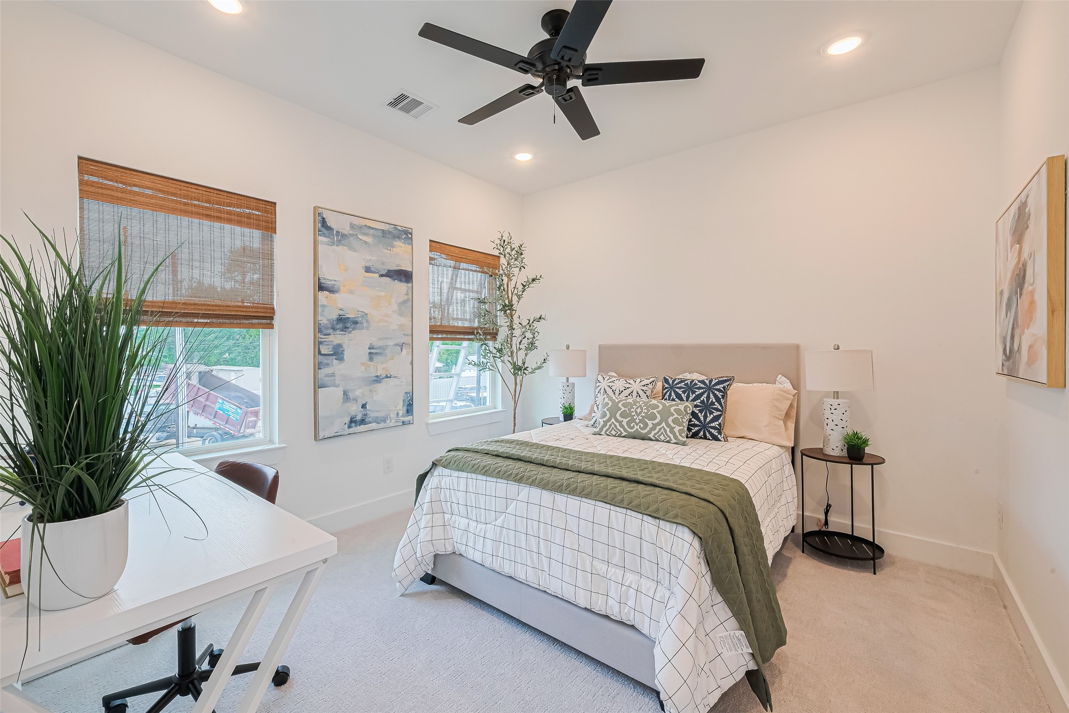 9437 Pembrook Street Houston, TX 77016 - Photo 12 of 25 a bedroom with a large bed and a potted plant