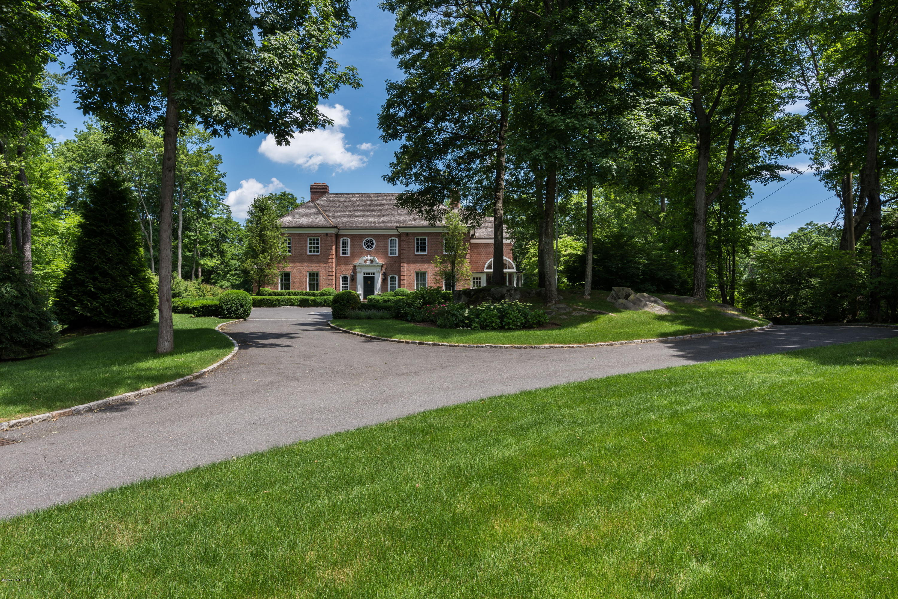526 North Street Greenwich, CT 06830 - Photo 1 of 40 a front view of a house with a yard and trees