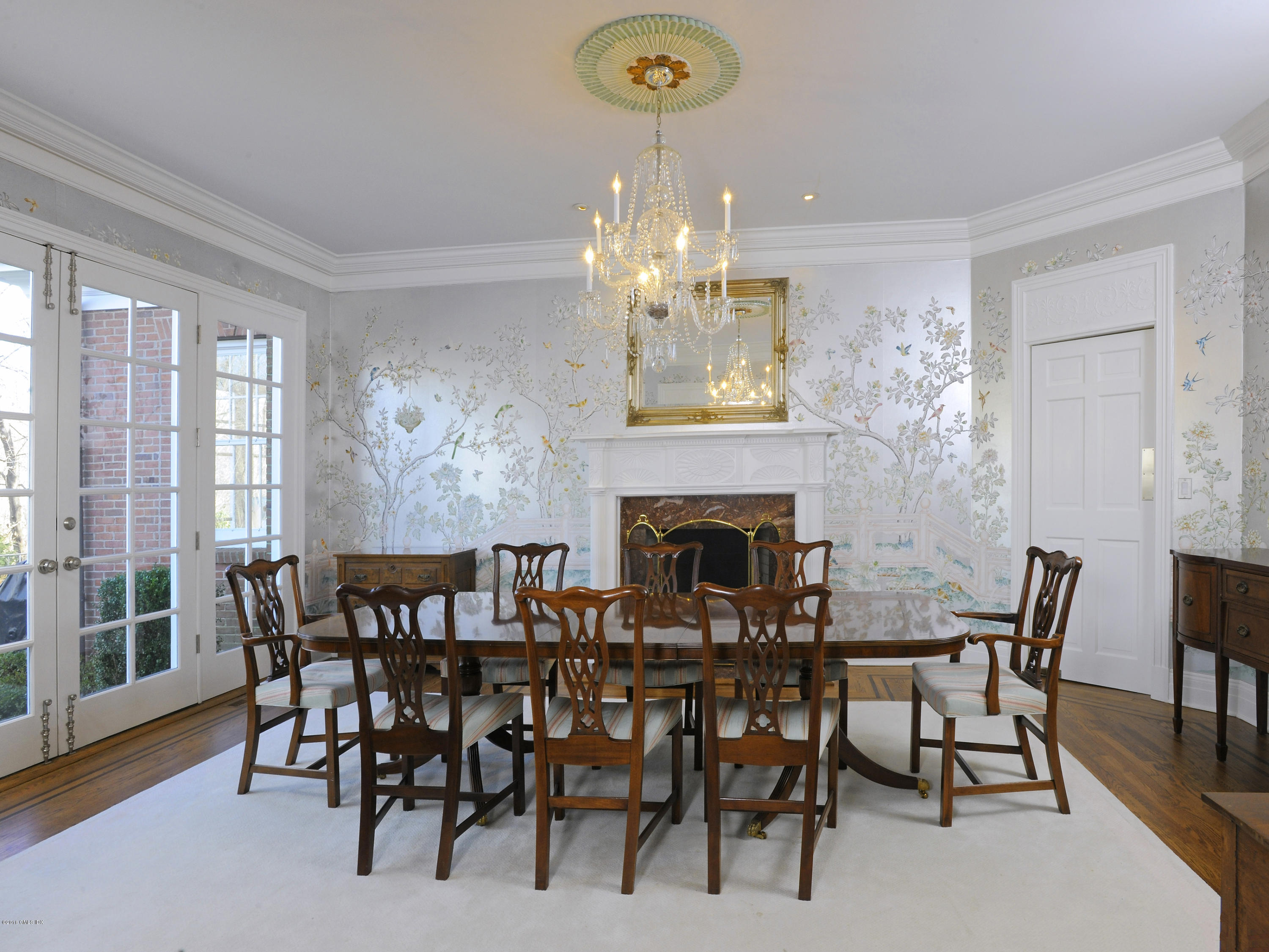 526 North Street Greenwich, CT 06830 - Photo 12 of 40 a view of a dining room with furniture a chandelier and wooden floor