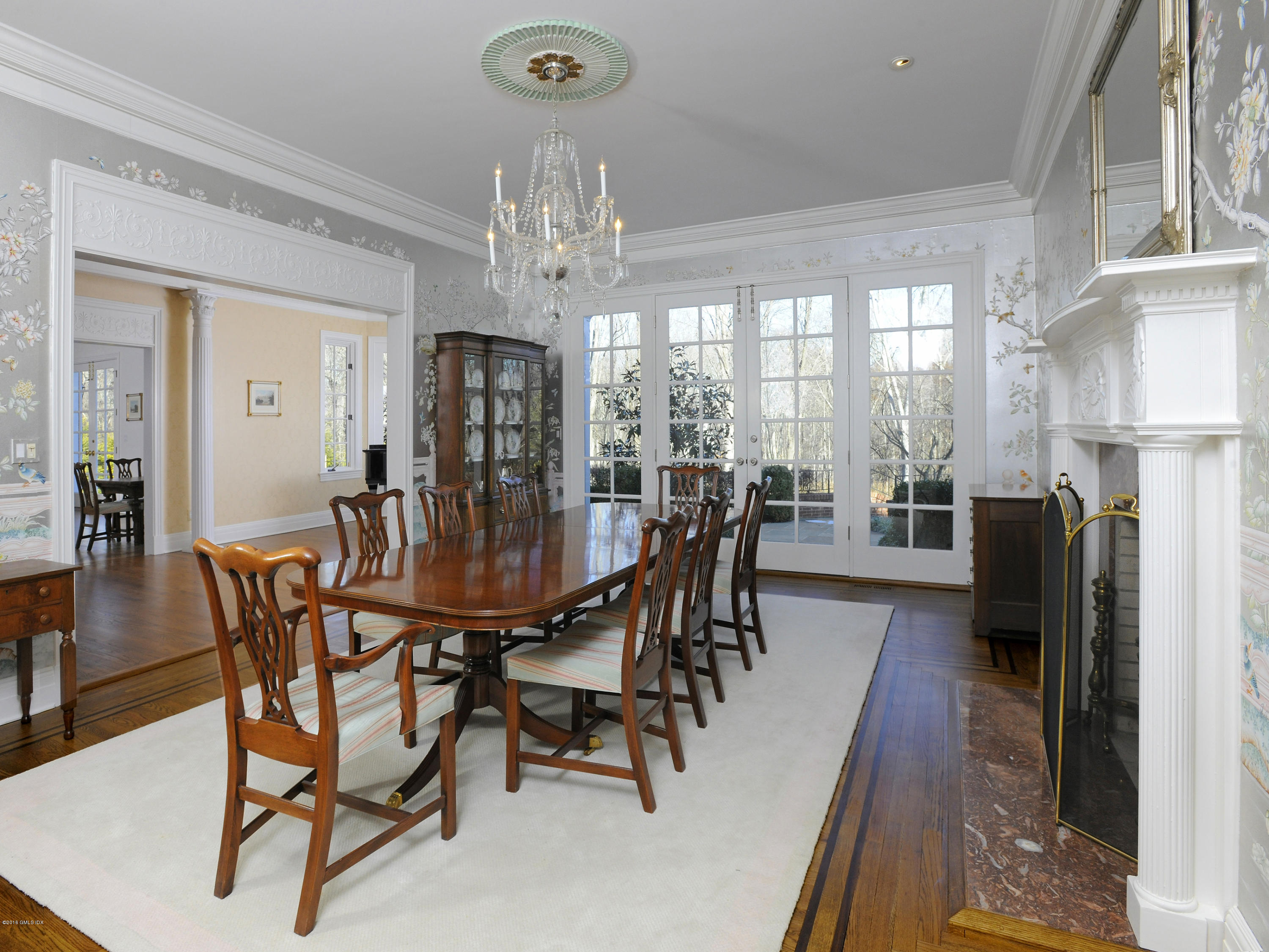 526 North Street Greenwich, CT 06830 - Photo 13 of 40 a view of a dining room with furniture a chandelier and wooden floor