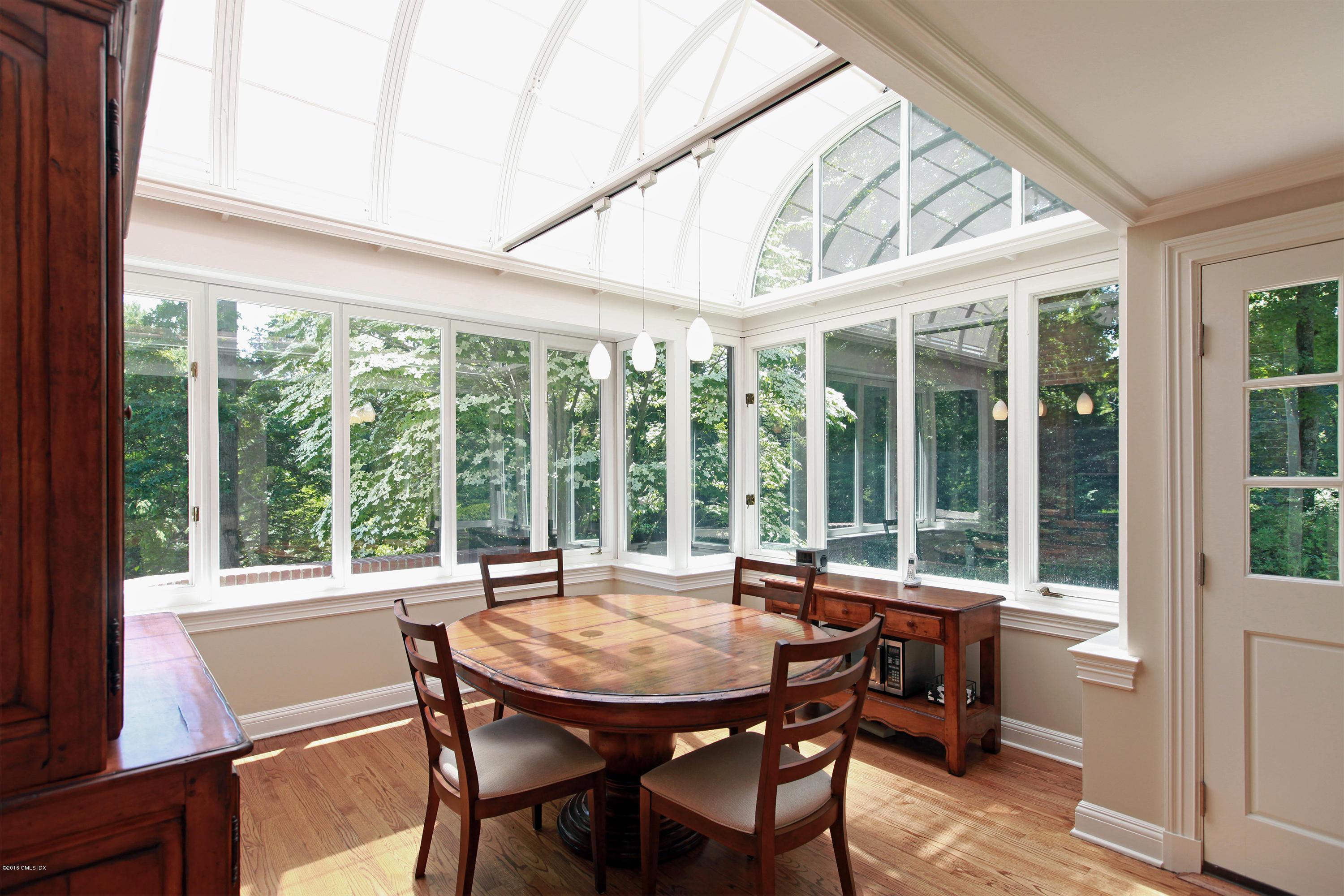 526 North Street Greenwich, CT 06830 - Photo 18 of 40 a view of a dining room with furniture large windows and wooden floor