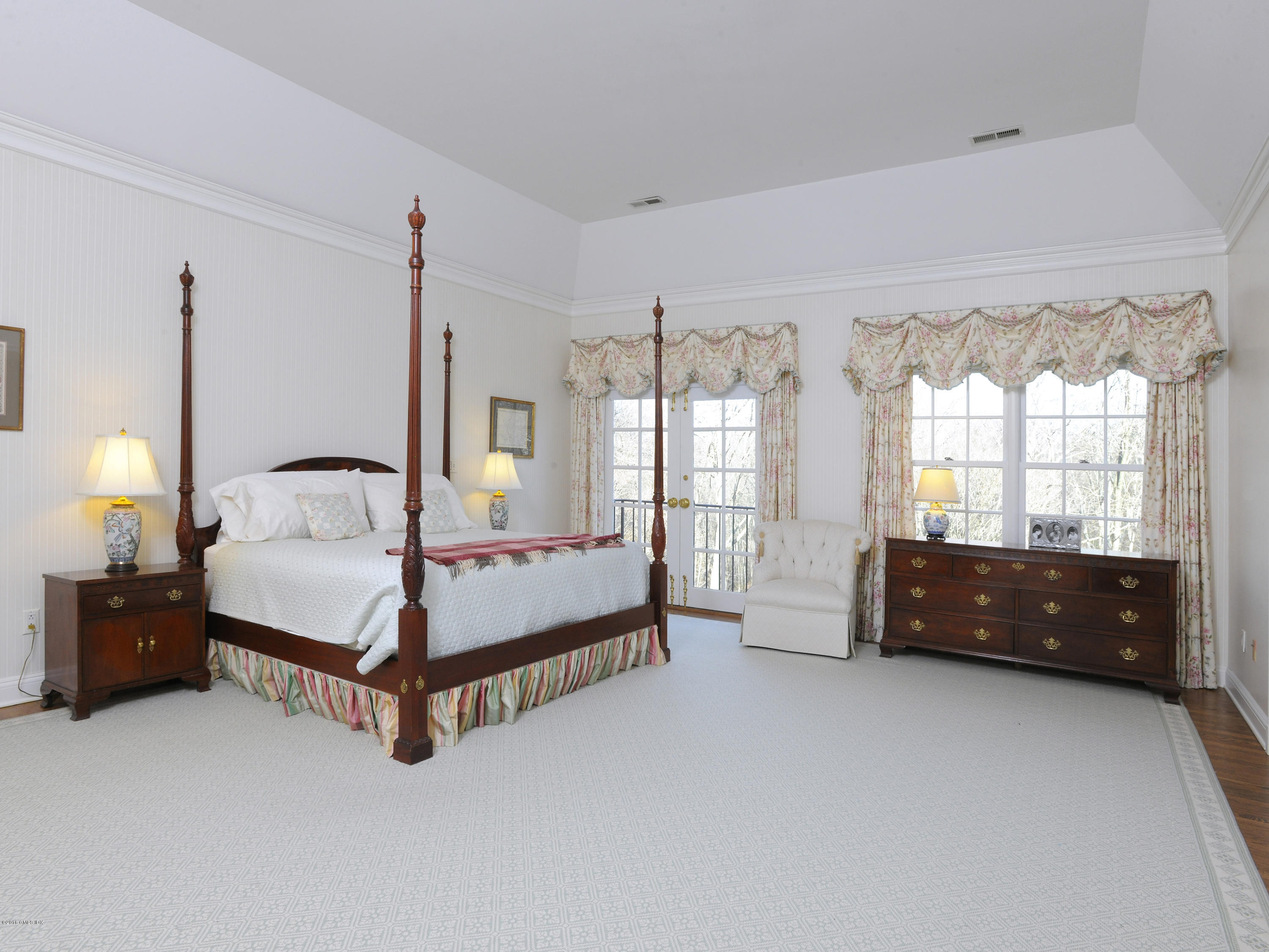526 North Street Greenwich, CT 06830 - Photo 20 of 40 a spacious bedroom with a bed and a window
