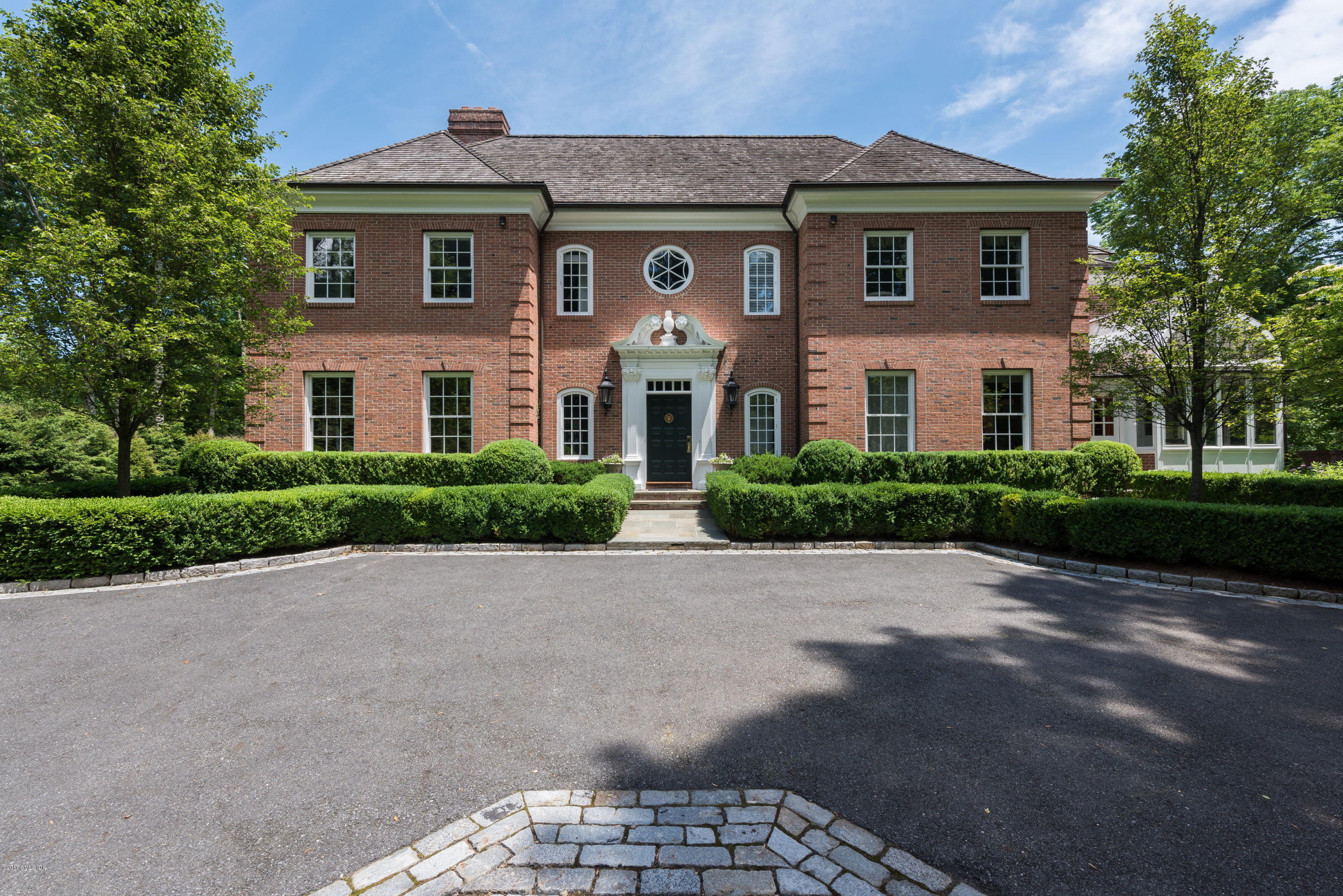 526 North Street Greenwich, CT 06830 - Photo 2 of 40 a front view of a house with a yard