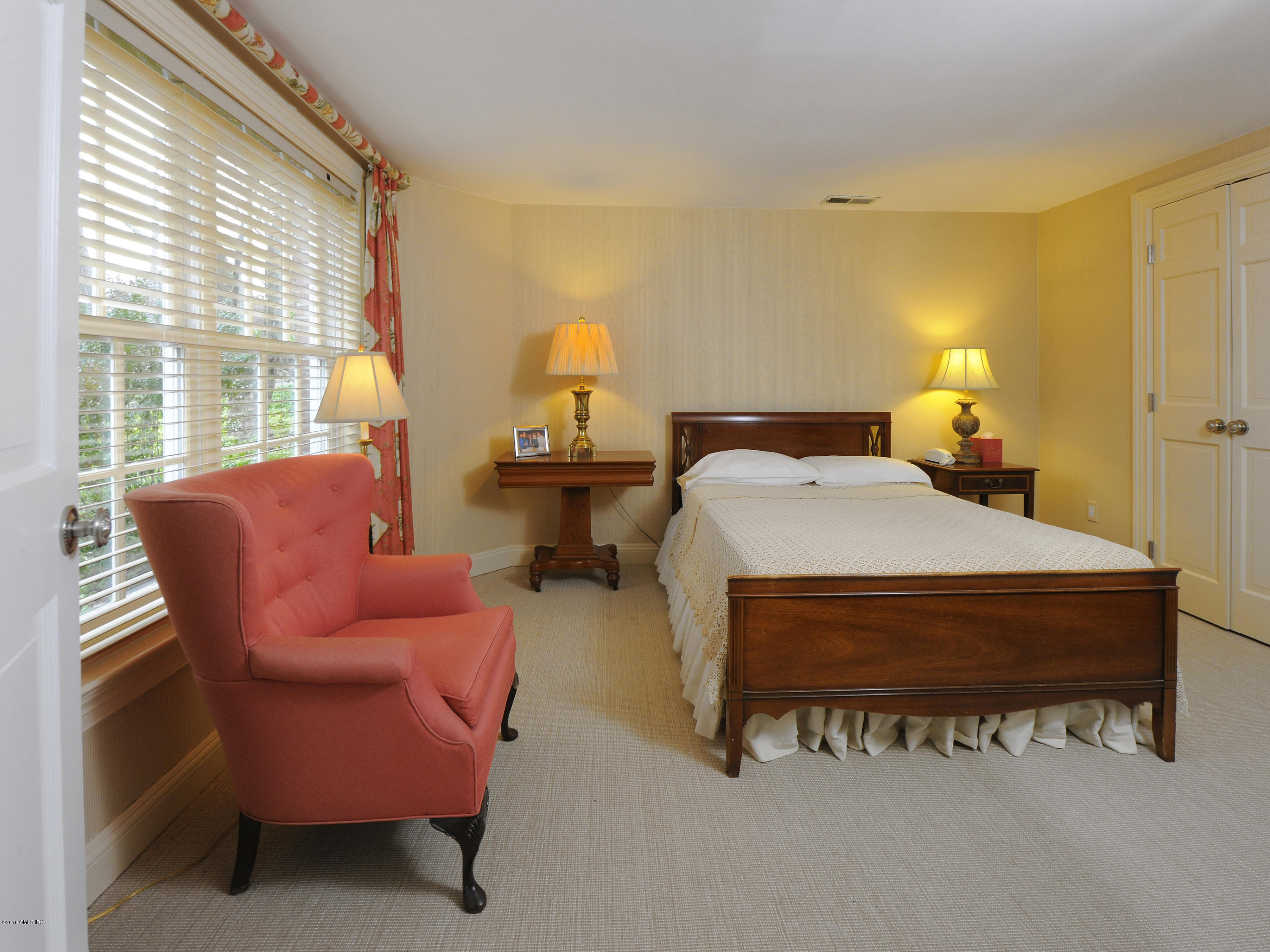 526 North Street Greenwich, CT 06830 - Photo 30 of 40 a bed room with a bed and a chair