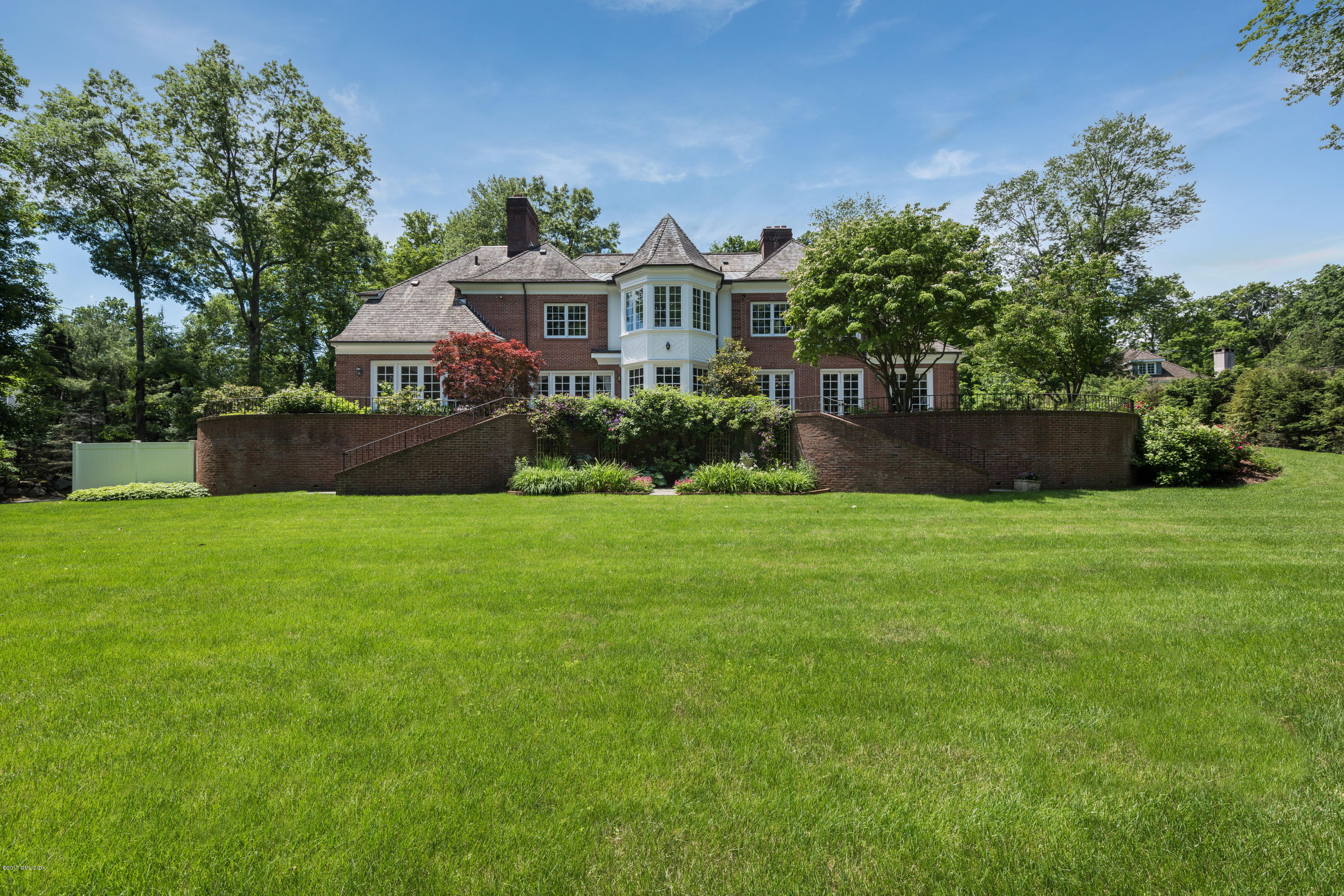 526 North Street Greenwich, CT 06830 - Photo 3 of 40 a front view of a house with a yard and green space