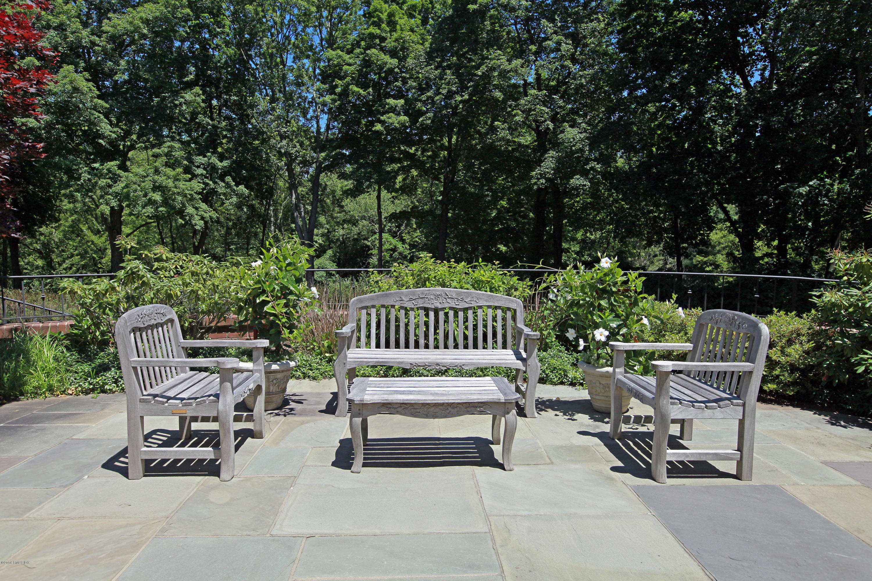 526 North Street Greenwich, CT 06830 - Photo 39 of 40 a view of a chairs and tables in the back yard of the house