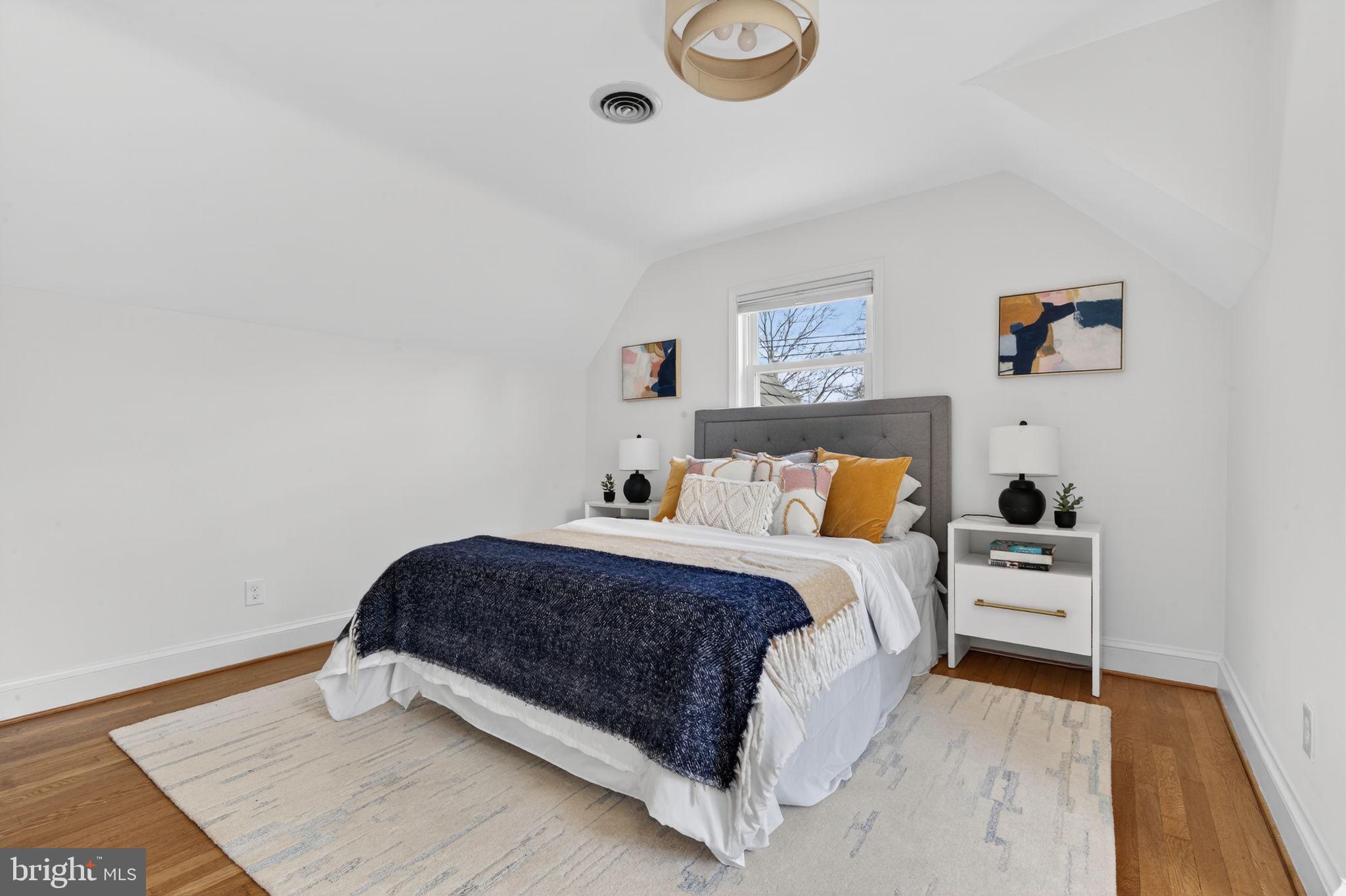 406 Dale Drive Silver Spring, MD 20910 - Photo 34 of 60 a spacious bedroom with a bed and a wooden floor