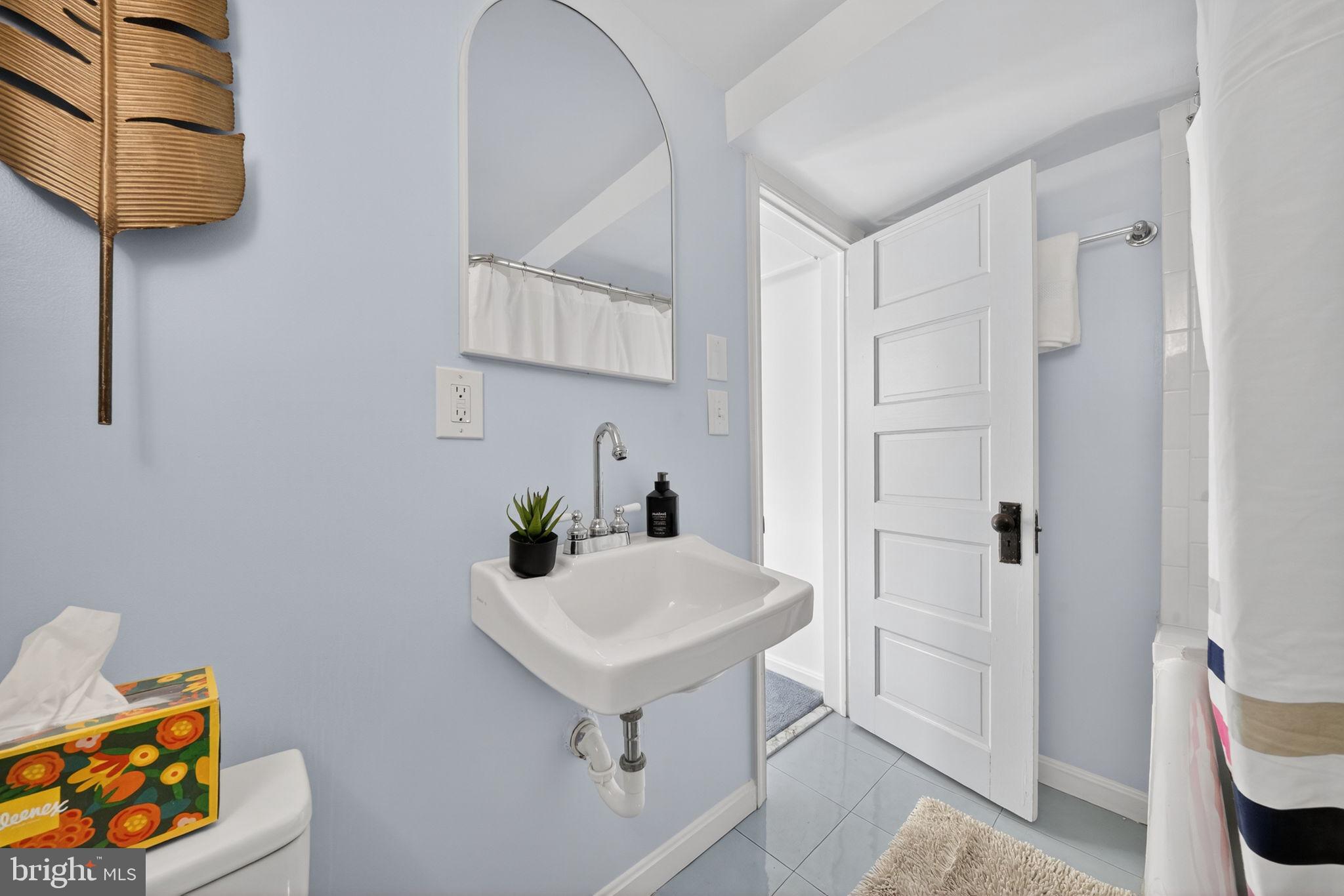 406 Dale Drive Silver Spring, MD 20910 - Photo 47 of 60 a bathroom with a sink and a mirror