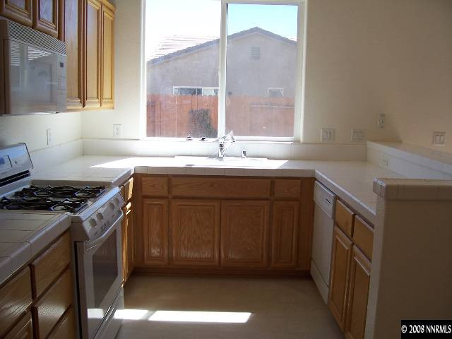 10520 Meeks Bay Court Reno, NV 89521 - Photo 4 of 9 a kitchen with a sink stove and cabinets