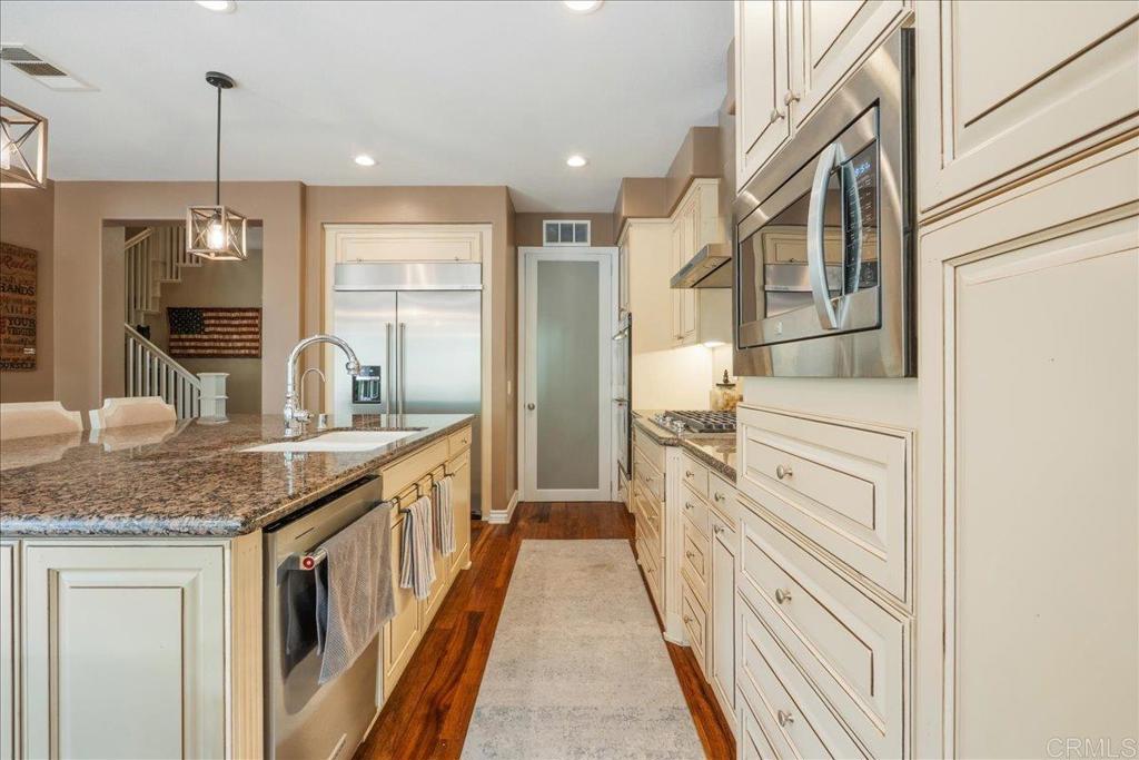 6996 Goldstone Road Carlsbad, CA 92009 - Photo 12 of 49 a kitchen with stainless steel appliances granite countertop a sink and dishwasher