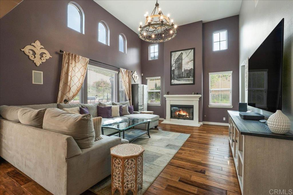 6996 Goldstone Road Carlsbad, CA 92009 - Photo 16 of 49 a living room with furniture a large window and a fireplace