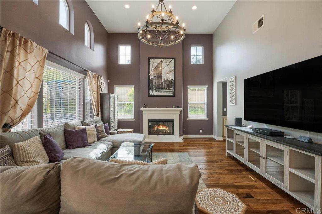 6996 Goldstone Road Carlsbad, CA 92009 - Photo 17 of 49 a living room with furniture a flat screen tv and a fireplace