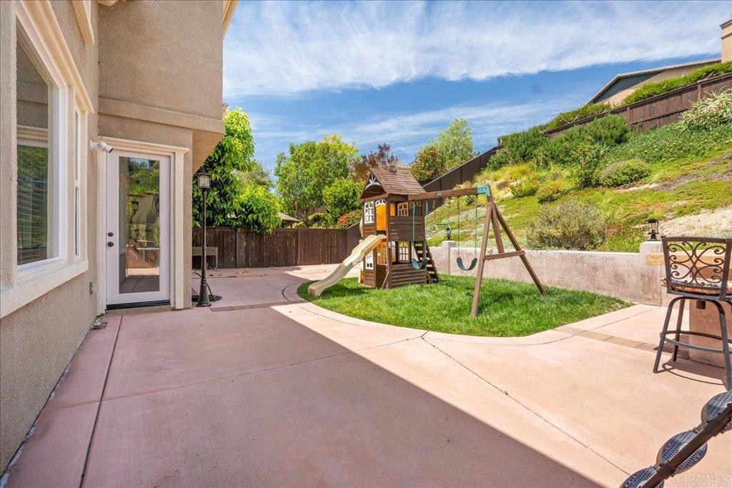 6996 Goldstone Road Carlsbad, CA 92009 - Photo 24 of 49 a view of a backyard with plants garage and chair