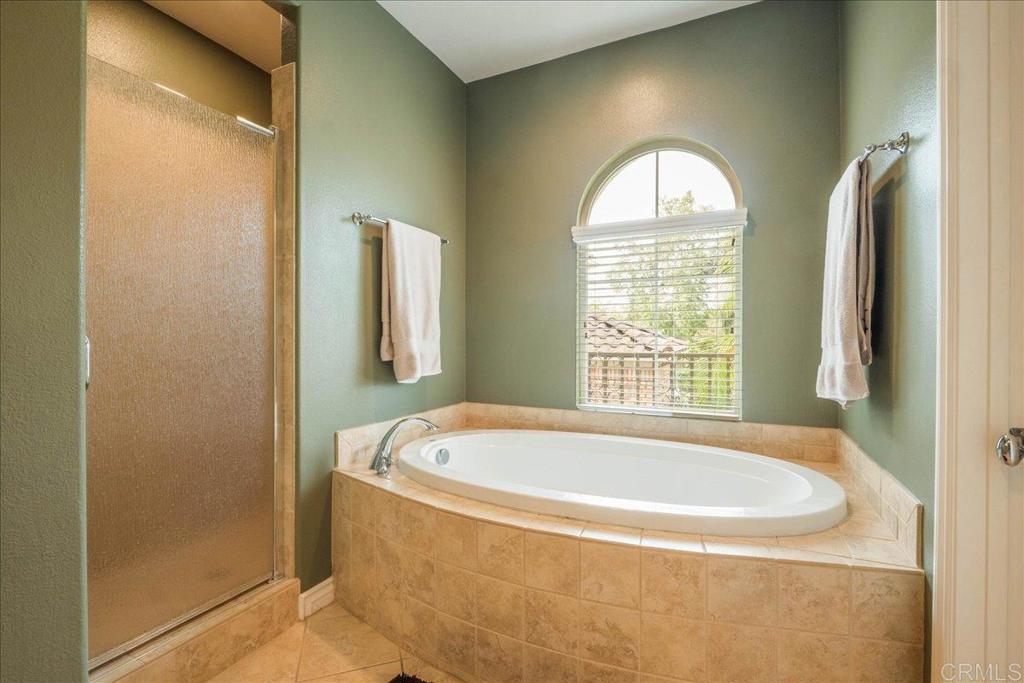 6996 Goldstone Road Carlsbad, CA 92009 - Photo 29 of 49 a bath tub sitting in a bathroom next to a window