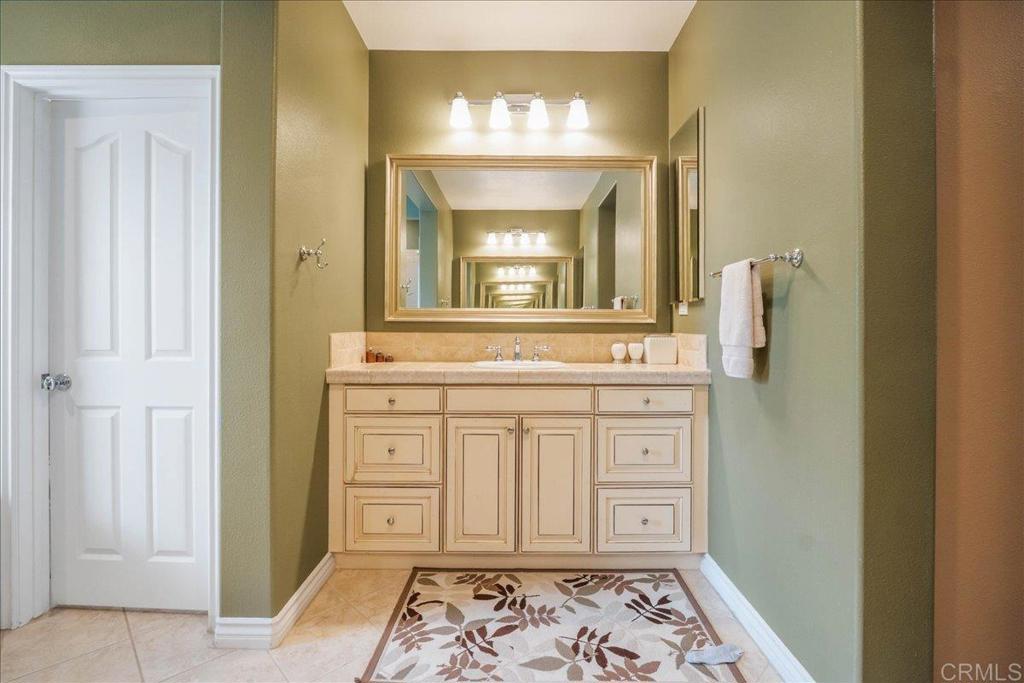 6996 Goldstone Road Carlsbad, CA 92009 - Photo 30 of 49 a bathroom with a sink and a mirror