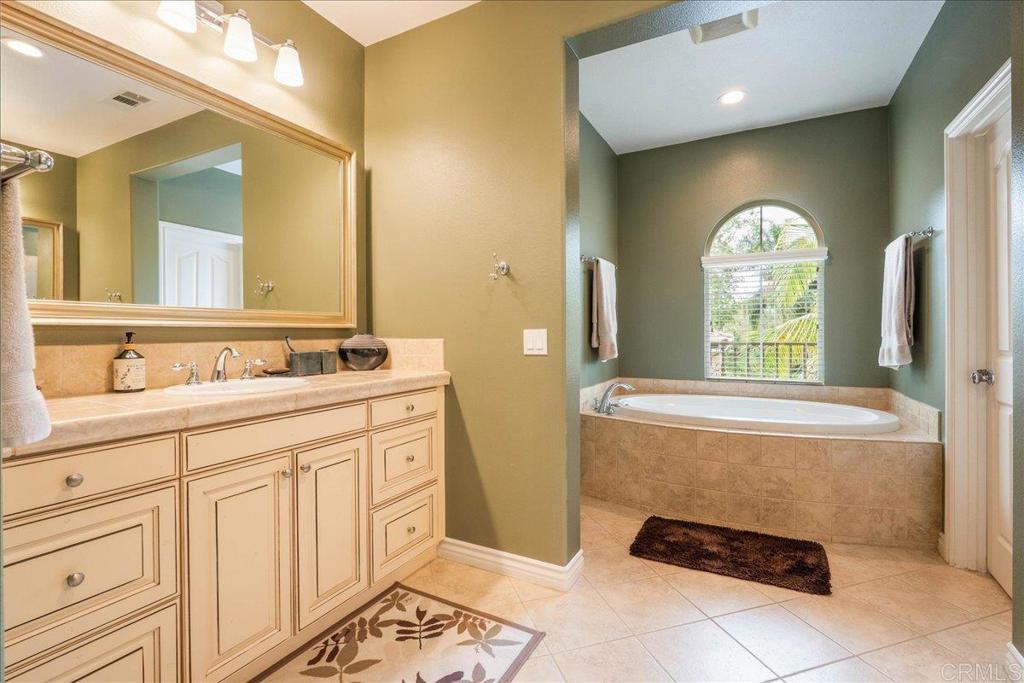 6996 Goldstone Road Carlsbad, CA 92009 - Photo 31 of 49 a spacious bathroom with a double vanity sink and a mirror