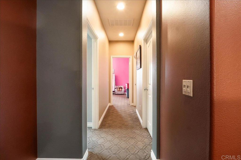 6996 Goldstone Road Carlsbad, CA 92009 - Photo 35 of 49 a view of a hallway with wooden floor and a living room
