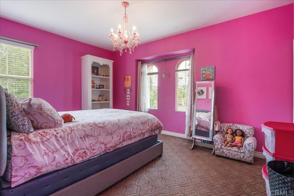 6996 Goldstone Road Carlsbad, CA 92009 - Photo 37 of 49 a bed room with a bed and a chandelier