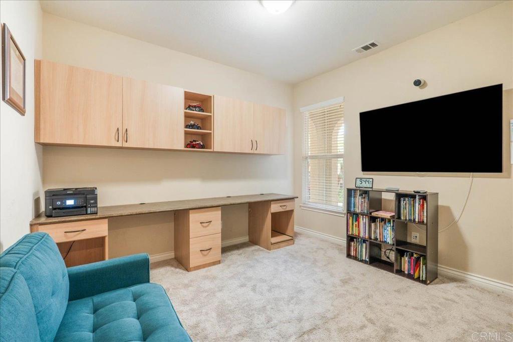 6996 Goldstone Road Carlsbad, CA 92009 - Photo 43 of 49 a living room with furniture and a flat screen tv