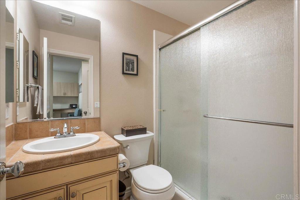 6996 Goldstone Road Carlsbad, CA 92009 - Photo 44 of 49 a bathroom with a sink toilet and a mirror
