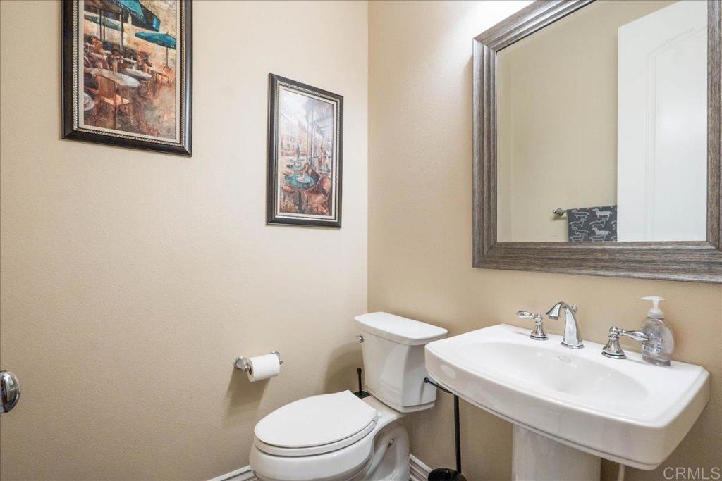 6996 Goldstone Road Carlsbad, CA 92009 - Photo 46 of 49 a white toilet sitting next to a bathroom sink