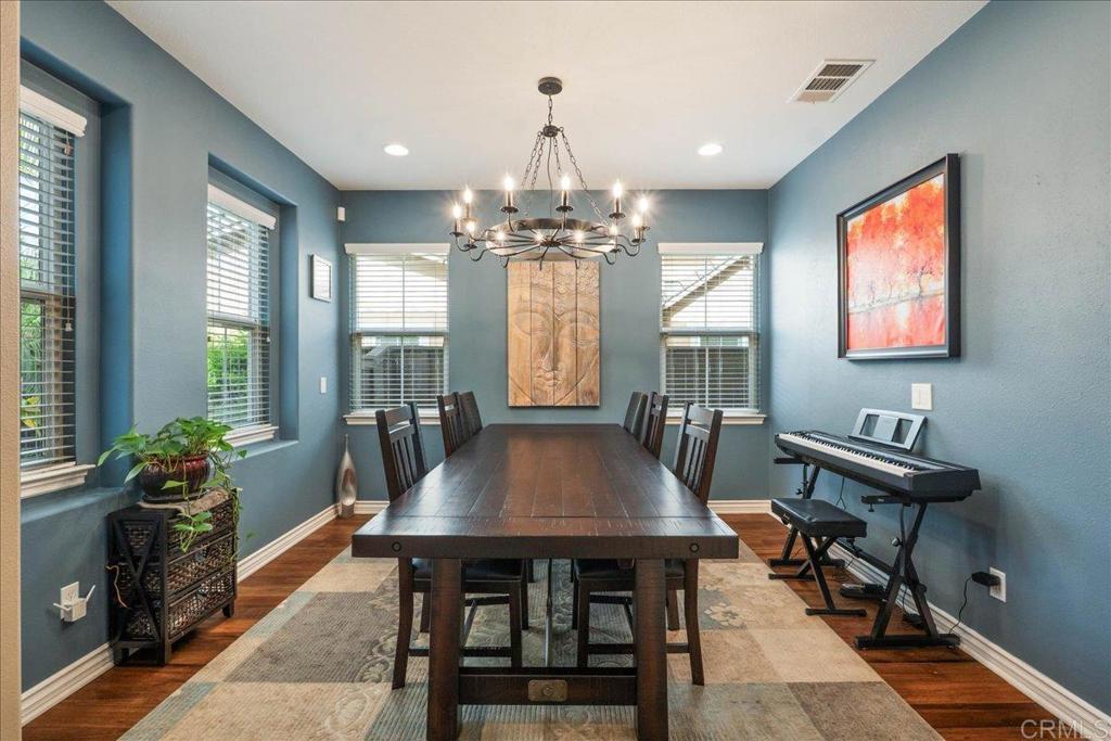 6996 Goldstone Road Carlsbad, CA 92009 - Photo 6 of 49 a view of a dining room with furniture window and wooden floor