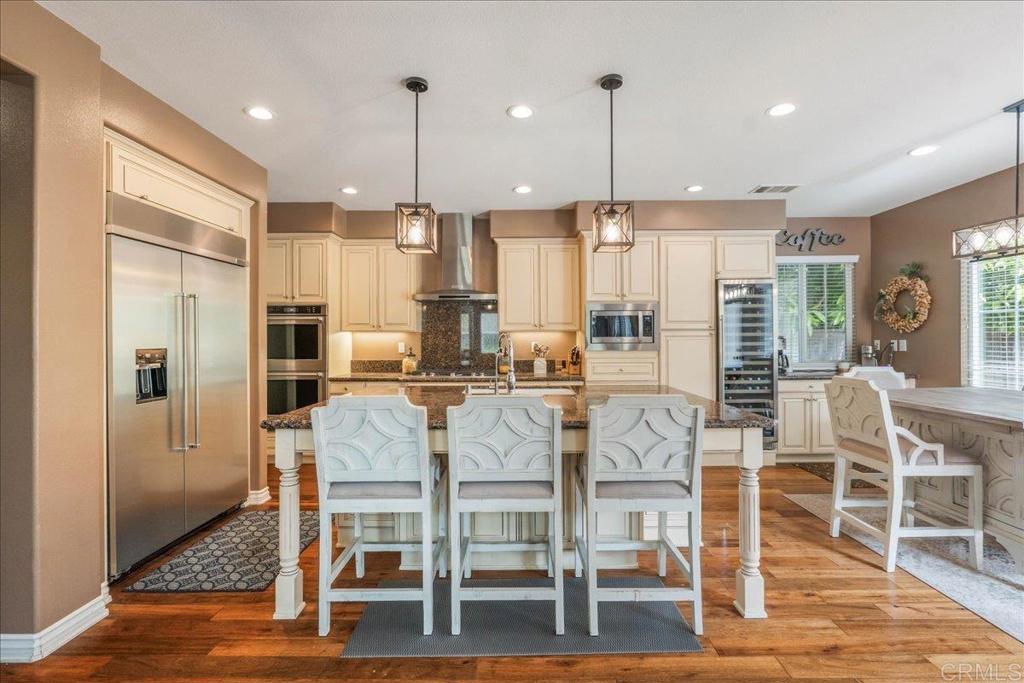6996 Goldstone Road Carlsbad, CA 92009 - Photo 7 of 49 a large kitchen with a table and chairs