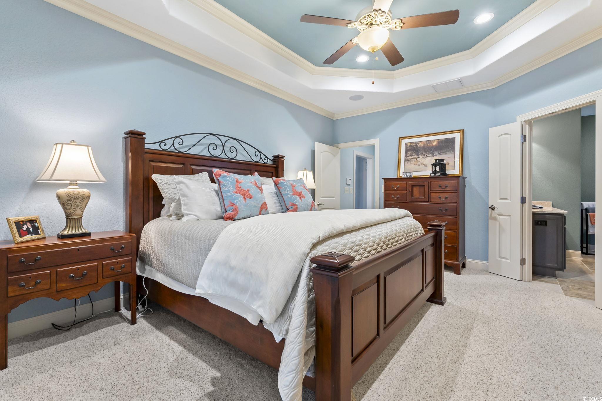 750 Villarosa Drive Myrtle Beach, SC 29572 - Photo 16 of 40 Bedroom with crown molding, light colored carpet, a tray ceiling, and ceiling fan