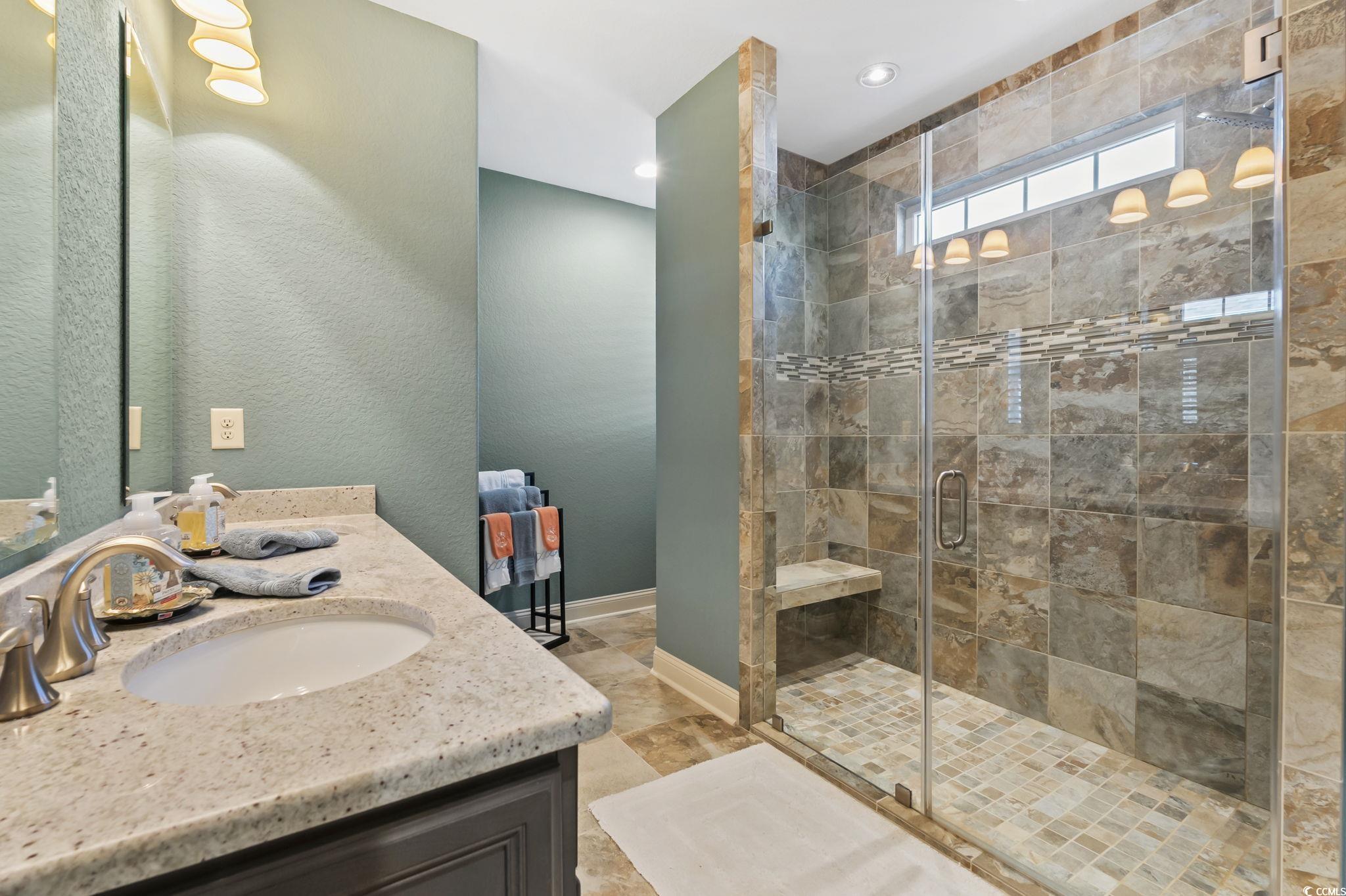 750 Villarosa Drive Myrtle Beach, SC 29572 - Photo 17 of 40 Bathroom with double vanity, a shower stall, a textured wall, and recessed lighting