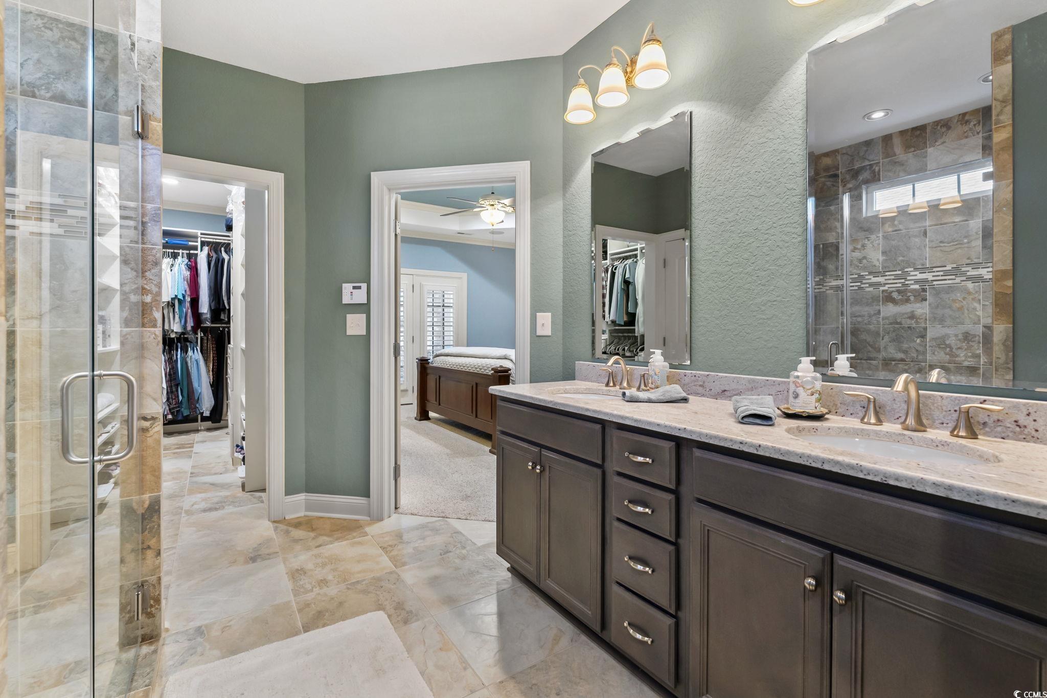 750 Villarosa Drive Myrtle Beach, SC 29572 - Photo 18 of 40 Bathroom featuring a spacious closet, double vanity, plenty of natural light, and a stall shower