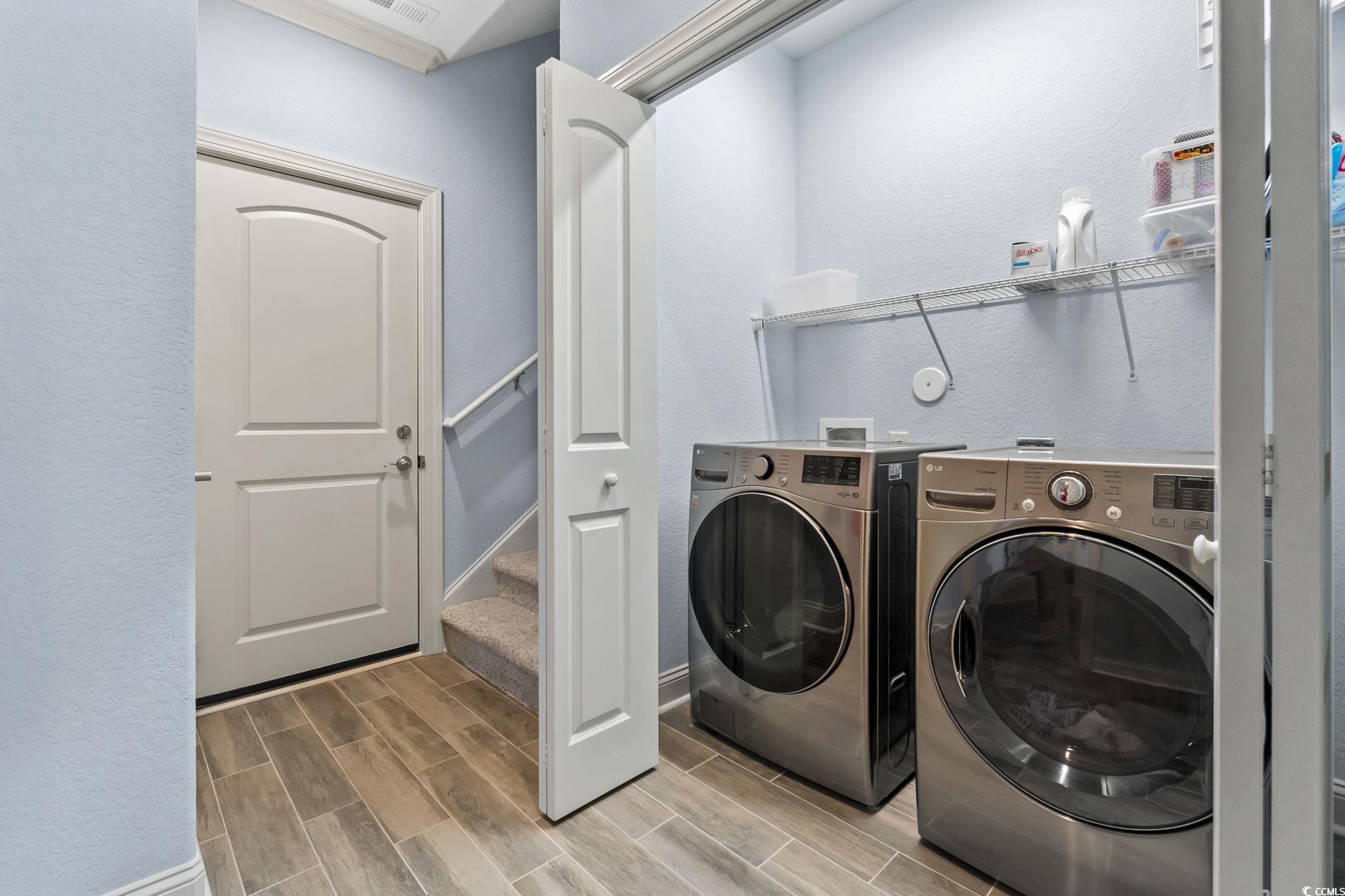 750 Villarosa Drive Myrtle Beach, SC 29572 - Photo 19 of 40 Laundry room with wood tiled floors, washing machine and dryer, and a textured wall