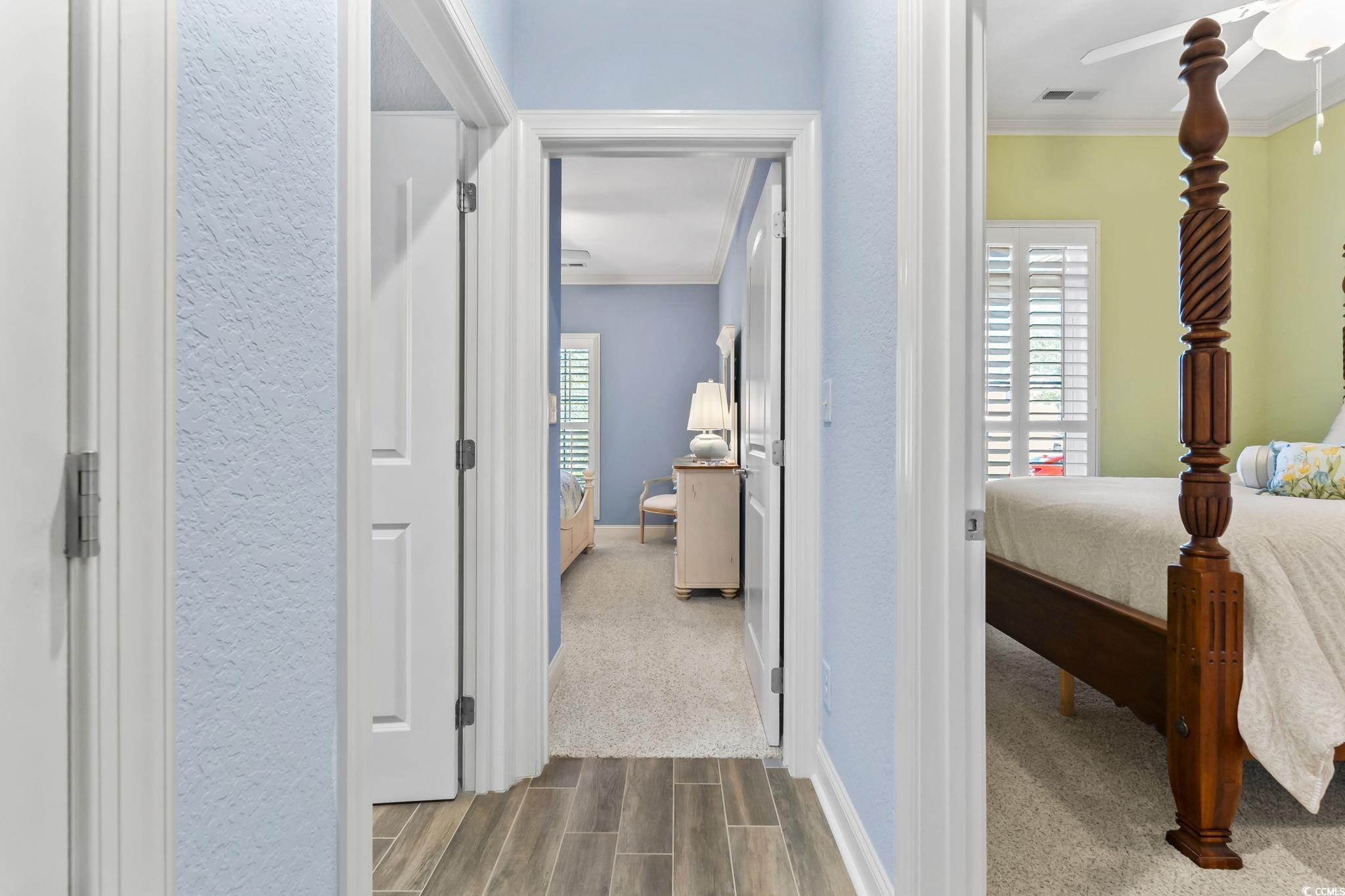 750 Villarosa Drive Myrtle Beach, SC 29572 - Photo 23 of 40 Hallway with crown molding, plenty of natural light, and wood tiled floors