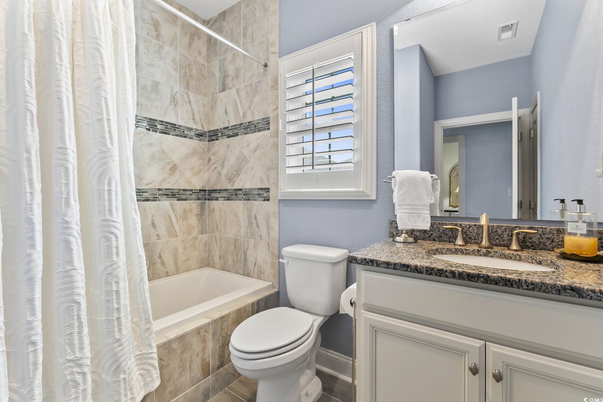750 Villarosa Drive Myrtle Beach, SC 29572 - Photo 24 of 40 Bathroom with tiled shower / bath combo and vanity