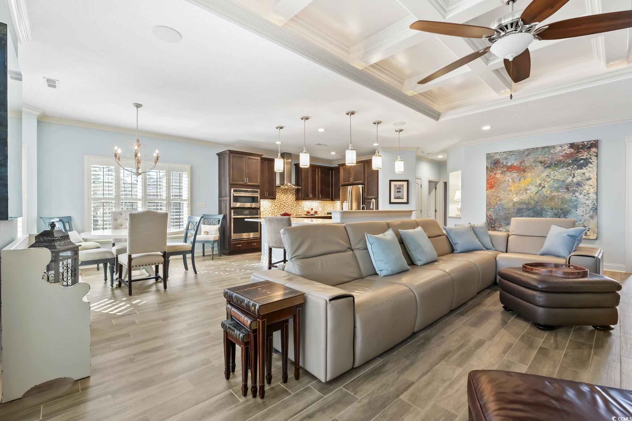 750 Villarosa Drive Myrtle Beach, SC 29572 - Photo 5 of 40 Living area featuring crown molding, a chandelier, wood tiled floors, ceiling fan, and coffered ceiling