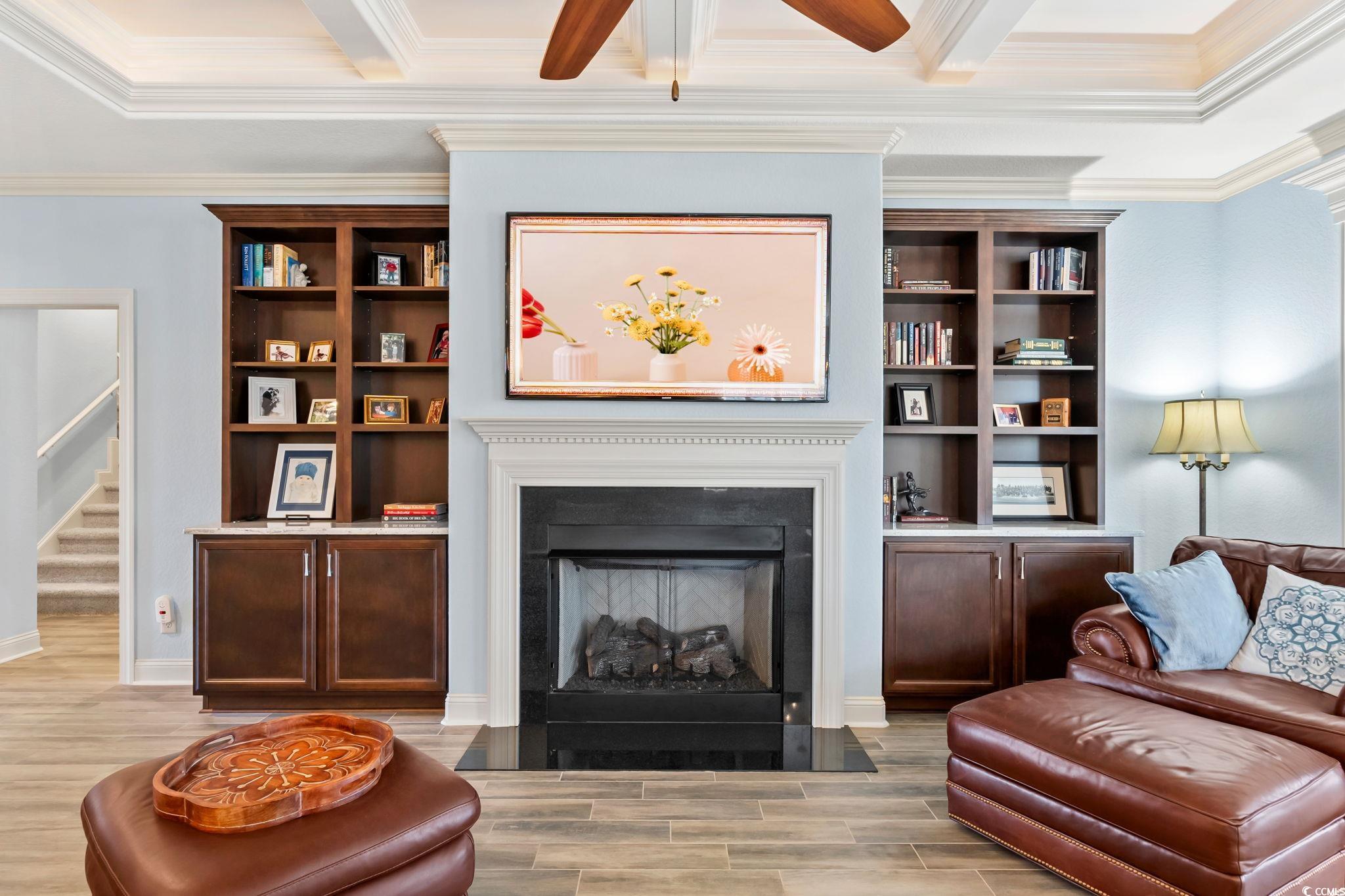 750 Villarosa Drive Myrtle Beach, SC 29572 - Photo 6 of 40 Living area with wood finish floors, a fireplace with flush hearth, crown molding, stairway, and a ceiling fan