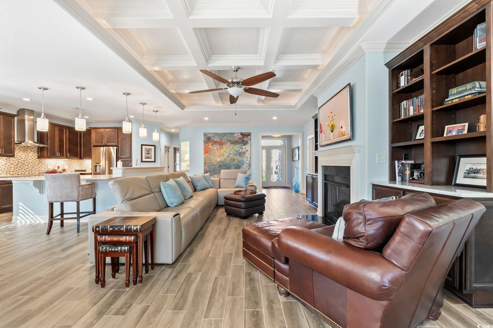 750 Villarosa Drive Myrtle Beach, SC 29572 - Photo 7 of 40 Living area with crown molding, a fireplace, coffered ceiling, a ceiling fan, and wood tiled floors