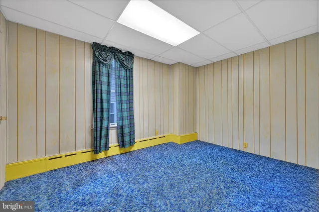 a view of a large house with a yard and large tree