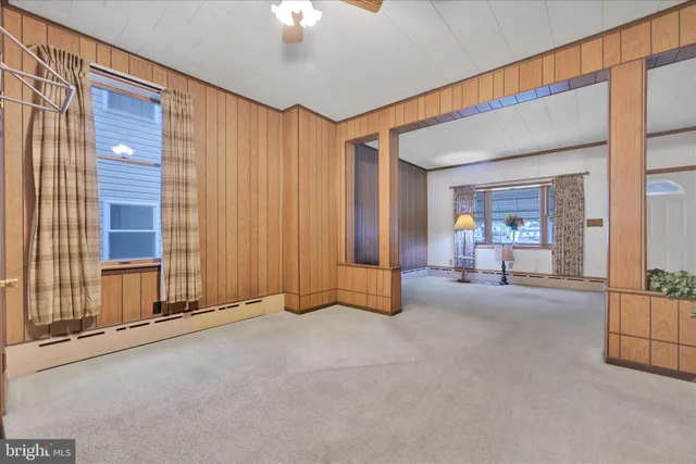 a kitchen with a table chairs refrigerator and cabinets
