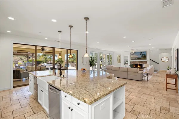 a kitchen with a dining table chairs and refrigerator