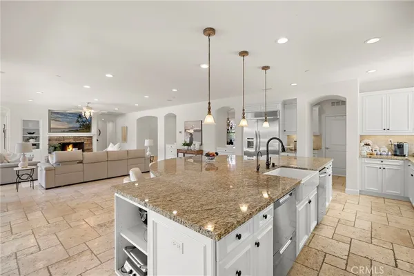 a kitchen with stainless steel appliances granite countertop a stove a sink island and a granite counter tops
