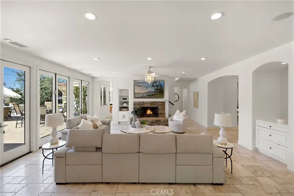 a living room with furniture a fireplace and a large window