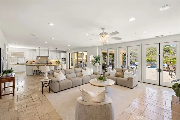 a living room with furniture and a chandelier