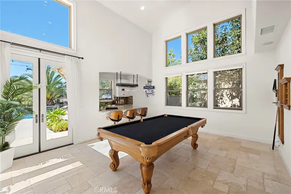 a bedroom with a large bed and a chandelier