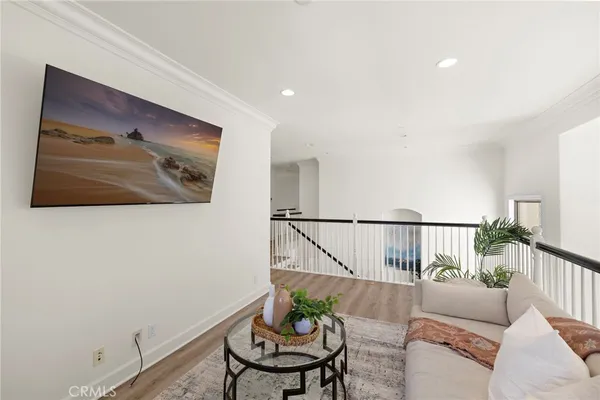a spacious bedroom with a large bed and a wooden floor
