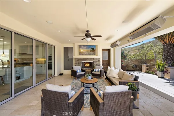 a living room with patio furniture and a large window