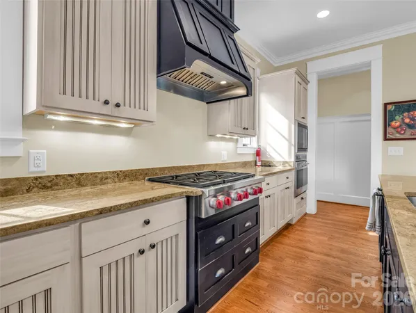 a bathroom with a tub a double vanity sink a window and mirror