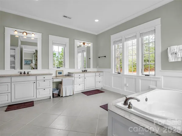 a bathroom with a granite countertop sink a mirror and shower