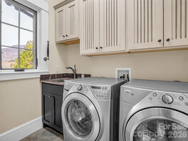a bedroom with two beds and a chandelier