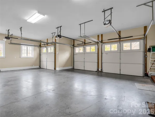 a bathroom with a tub a double vanity sink a large mirror and a bathtub next to a window